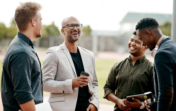 Maintaining that human connection helps your career thrive Shot of a group of businessmen meeting for coffee against a city background colleagues outside stock pictures, royalty-free photos & images