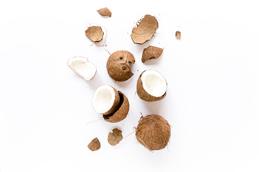 cracked coconut on white background. flat lat, top view. High quality photo