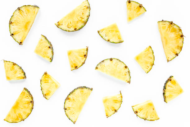 istock Slices pineapple with green leaves isolated on white background. Flat lay, top view 1277418425