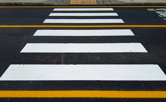 Crosswalk road signs and pedestrian crossing marking.