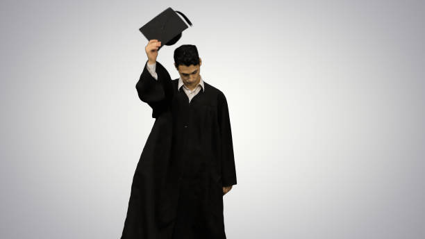 istock Male graduate walking in the frame, throwing his mortarboard and 1277420485