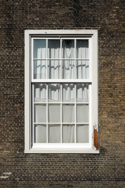 istock old wooden window on brown brick wall background, stone wall with little window 1277420709