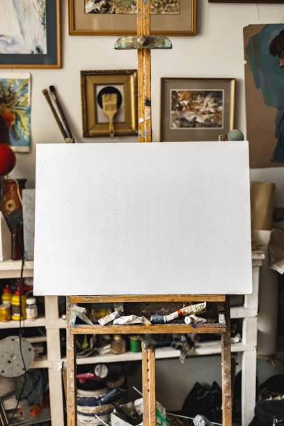 istock Canvas on easel at art studio indoors artistic background 1277421321