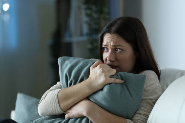 istock Scared woman embracing pillow at home in the night 1277425985