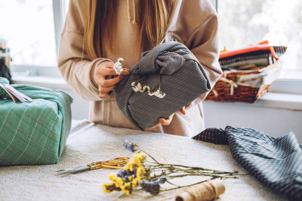 istock Furoshiki Japanese Gift Wrapping. Thanksgiving Zero waste, eco-friendly gift wrapping process, tutorial. Fall hand-wrapped gift in traditional Japanese Furoshiki style 1277426712