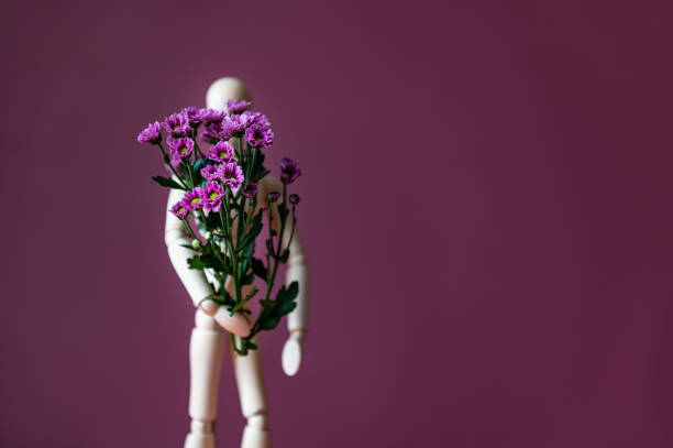 istock Wood man holding flowers 1277428440