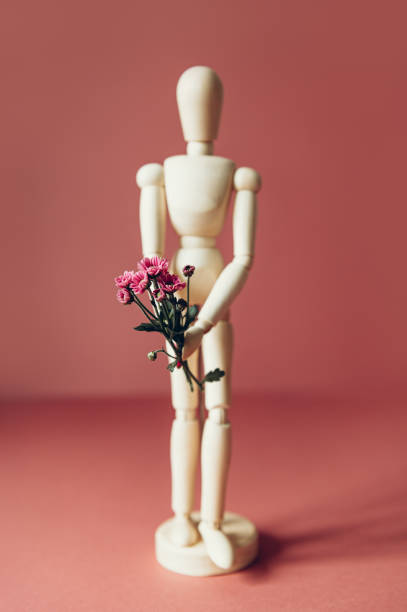 istock Wood man holding flowers 1277428441