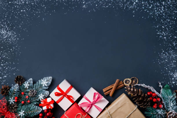 istock Christmas background with fir tree, Christmas present boxes, snowy fir branches, conifer cones,  gift on a dark background. Top view. Copy space. New Year. 1277430949
