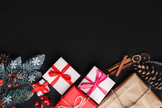 istock Christmas background with fir tree, present boxes, snowy fir branches, conifer cones,  gift on a dark background. Top view. Copy space. New Year. 1277430951