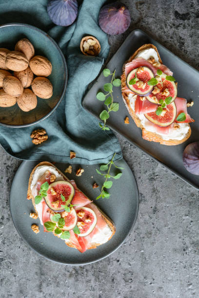 istock Sandwich with goat cheese, prosciutto, figs and walnuts 1277431128