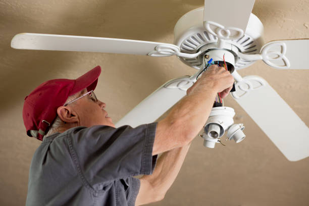 istock Blue Collar Workers.  Electrician repairing ceiling fan. 1277431413