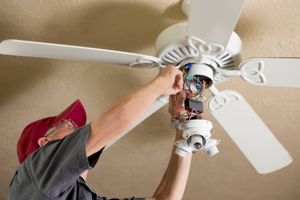 istock Blue Collar Workers.  Electrician repairing ceiling fan. 1277431447