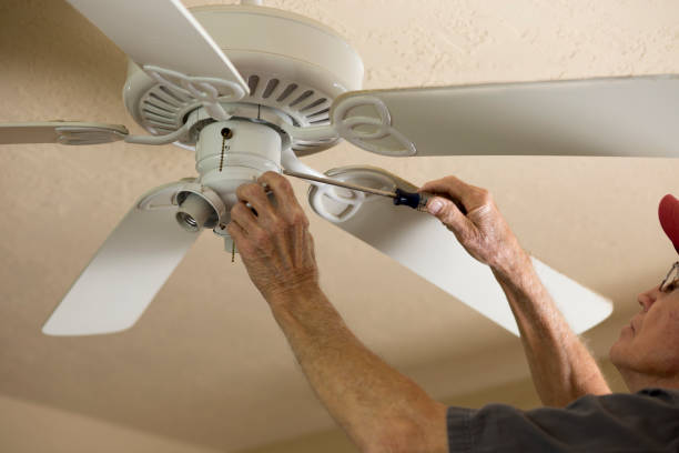 istock Blue Collar Workers.  Electrician repairing ceiling fan. 1277431505