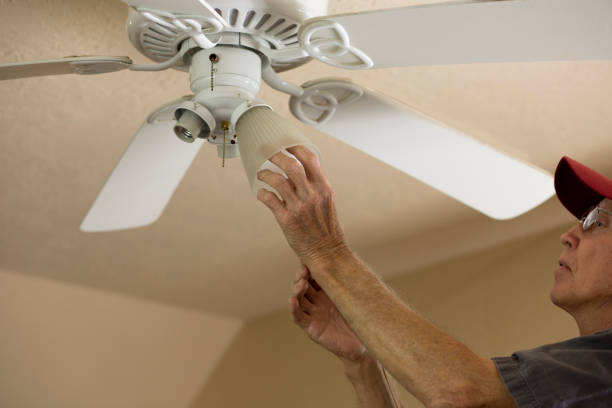 istock Blue Collar Workers.  Electrician repairing ceiling fan. 1277431510