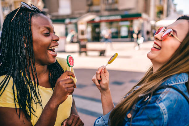 istock Female friends having fun with colorful lollipops 1277432350