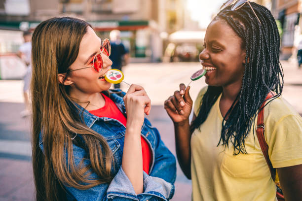 istock Female friends having fun with colorful lollipops 1277432645