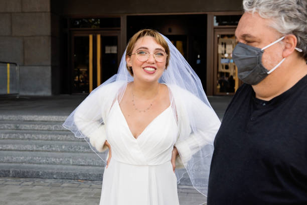 istock Newlywed bride and father leaving courthouse after wedding during Covid. 1277432657