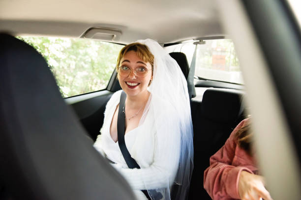 istock Millennial future bride sitting backseat to go to wedding. 1277432694
