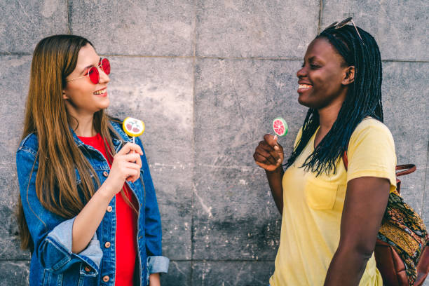 istock Women tasting colorful candies 1277433544
