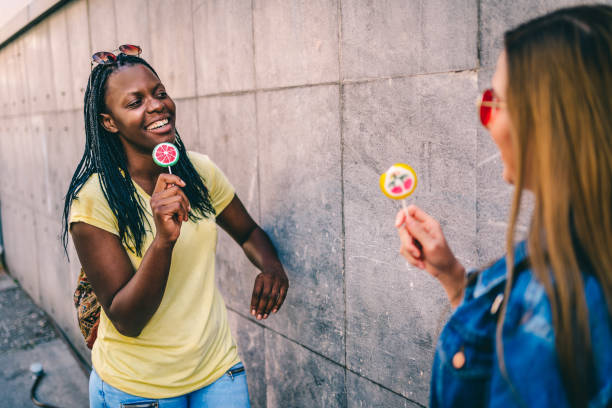 istock Women tasting colorful candies 1277433595