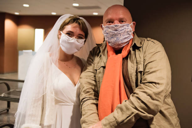 istock Bride and godfather wearing face masks for wedding during Covid. 1277434581