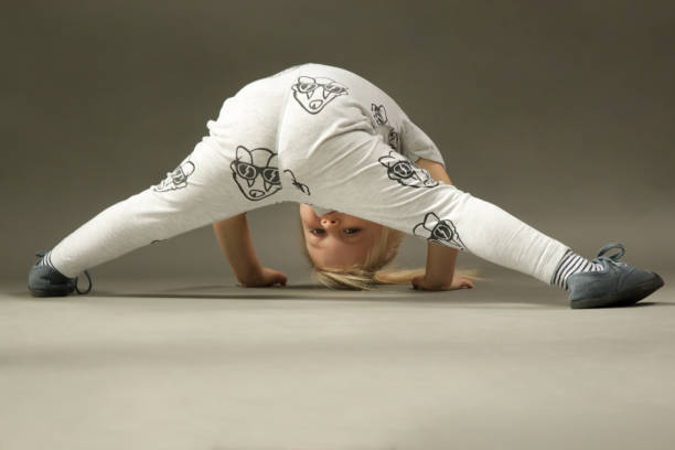 istock Tree years old toddler girl learning to roll forward, studio shot 1277434608