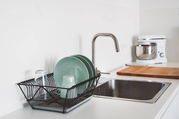 istock Clean dishes drying on dish drainer next to the sink 1277434678