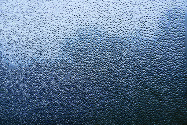 istock Condensate. Raindrops on window pane close-up. 1277435459