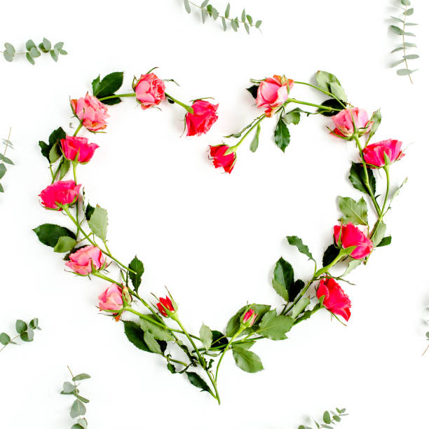 istock The heart is lined with red roses on white background. Valentine's background. Floral pattern. Flat lay, top view 1277435833