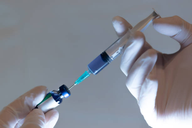 istock Hand Holding a Medical Syringe With A Vaccine 1277437114