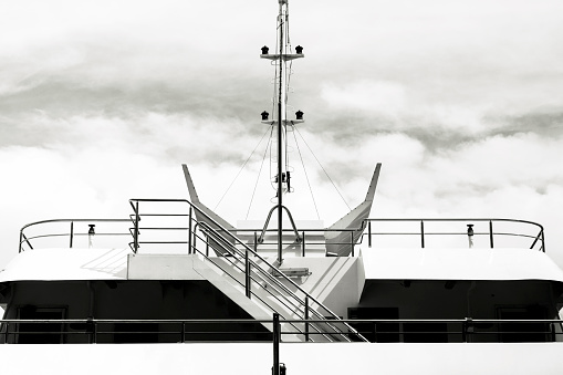 Black and white front view of luxury yacht, background with copy space, horizontal composition