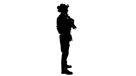 Wide shot. Side view. Soldier with machine gun standing, Alpha Channel Professional shot in 4K resolution. 048. You can use it e.g. in your medical, commercial video, business, presentation, broadcast