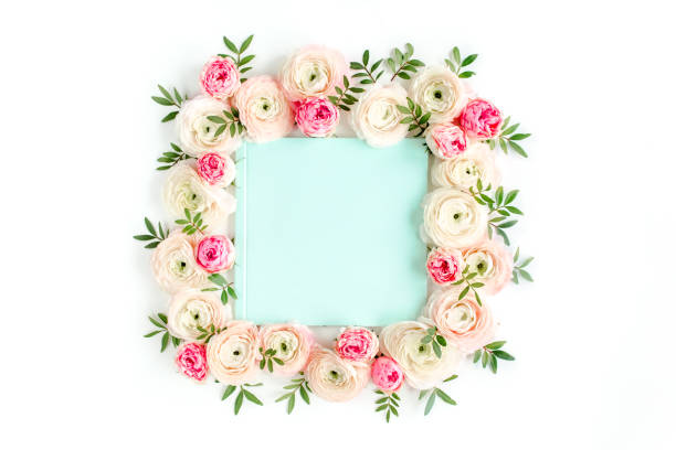 istock Floral pattern frame made of pink ranunculus and roses flower buds on white background. Flat lay, top view floral background 1277441992