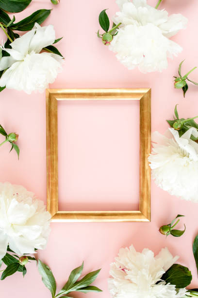 istock Frame of white peony flowers with space for text on pink background. Peony texture. Flat lay, top view 1277445290