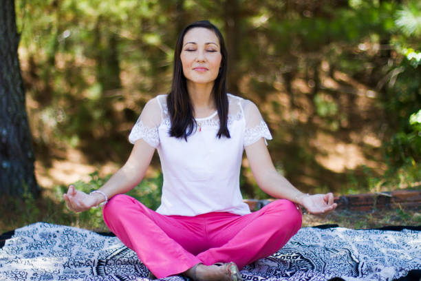 istock Woman meditating outdoors 1277445436