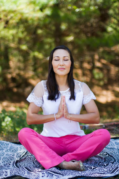 istock Woman meditating outdoors 1277445440