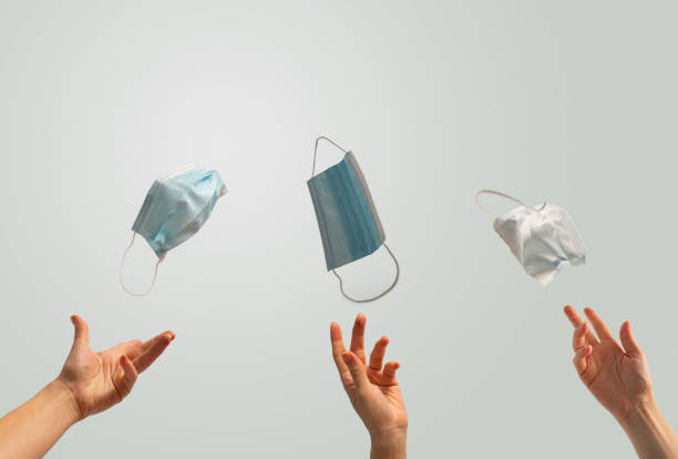 istock After Coronavirus concept, people throwing away protective masks 1277448175