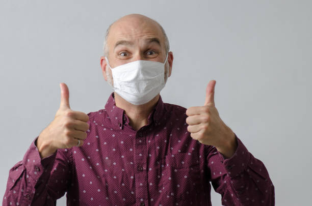 istock Man smiling under his mask during pandemic 1277448235