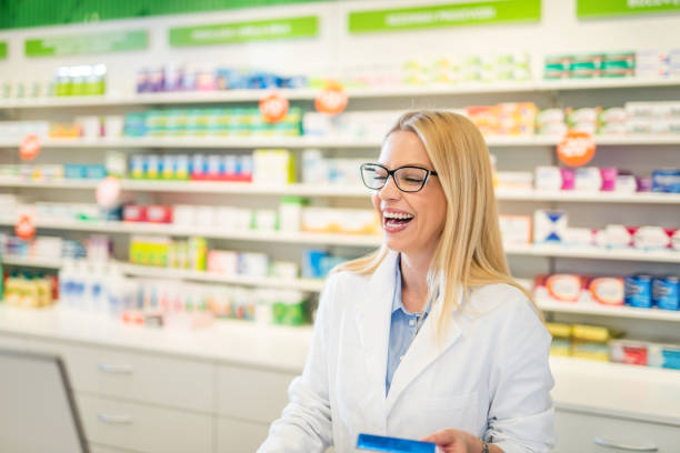 istock Laughing female pharmacist at her workplace. 1277449103