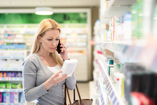 Mid Adult woman browsing in a Pharmacy.