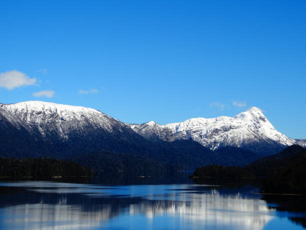 istock Snowy mountains reflected in the water 1277451220