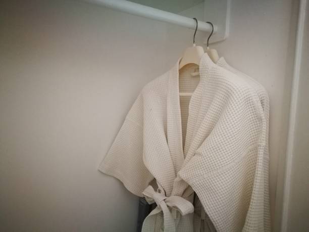 istock White bathing gown, bathing wrap hang on closet. White cloak. 1277455666