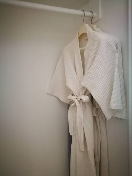 istock White bathing gown, bathing wrap hang on closet. White cloak. 1277455800