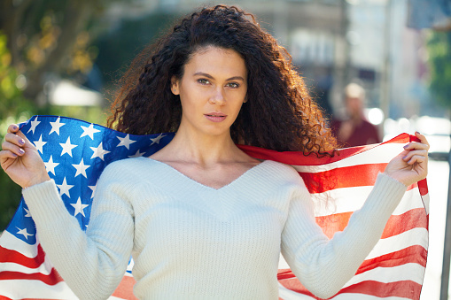 Young woman holding the American flag