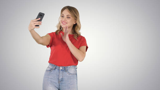 istock Cute girl making selfie walking on gradient background 1277457716