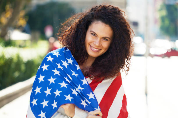 istock Young woman holding the American flag 1277457732