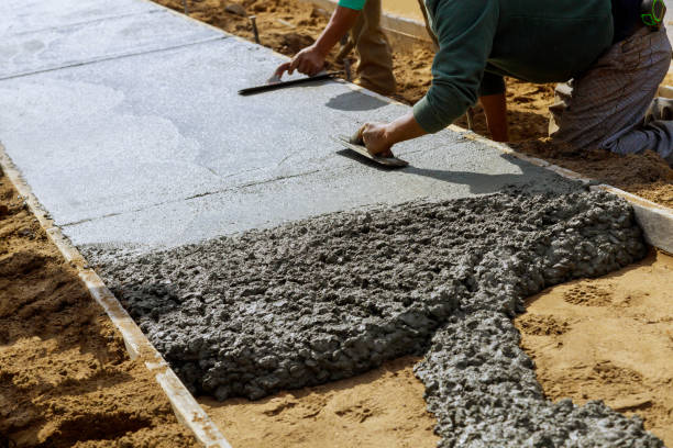 istock Laying down a new sidewalk in wet concrete on freshly poured sidewalks 1277462092