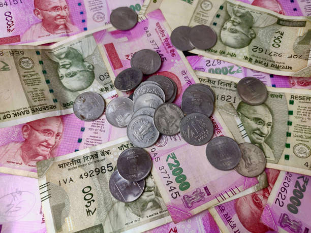 istock bank note and coins , indian 2000 and 500 rs currency 1277462699