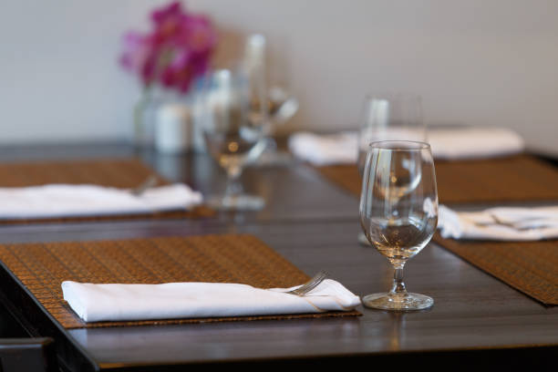 istock Dining table with spoon, knife and glass, with napkin and dish plate on the dining table. 1277462890
