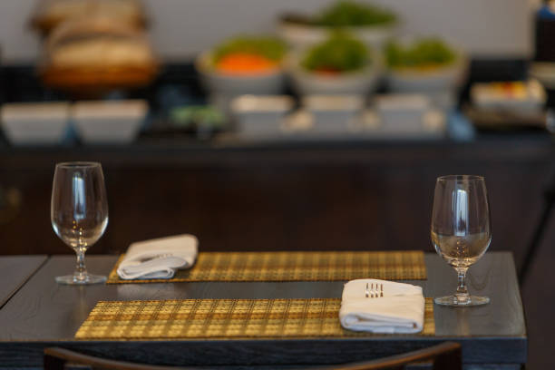 istock Dining table with spoon, knife and glass, with napkin and dish plate on the dining table. 1277462906